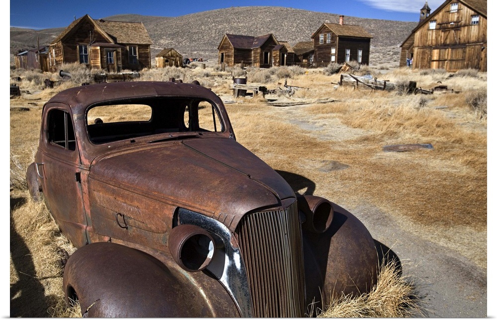 Download Poster Print "Old rusty car surrounded by abandoned houses ...