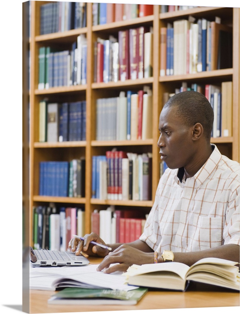 Solid-Faced Canvas Print Wall Art entitled College student working in library Solid-Faced Canvas Print Wall Art entitled College student working in library